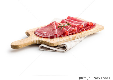 Smoked bresaola. Italian appetizer. Dried beef meat isolated on white backgorund. 98547884