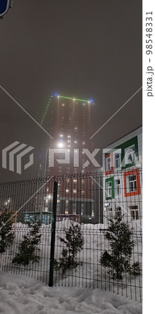 colored apartment buildings in the fog in night colored apartment buildings in the fog in night 98548331