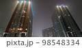 colored apartment buildings in the fog in night 98548334