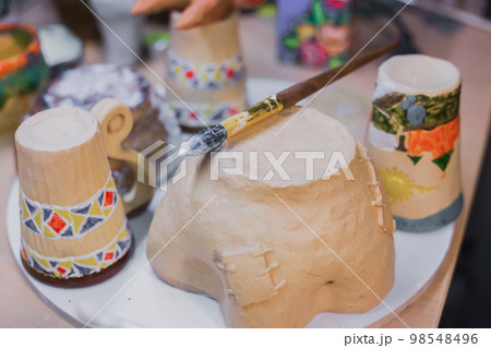 Unfinished earthenware on shelf of pottery workshop - close up Unfinished earthenware on shelf of pottery workshop - close up 98548496