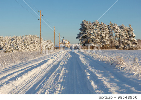 Country road after a snowstorm covered with snow Country road after a snowstorm covered with snow 98548950