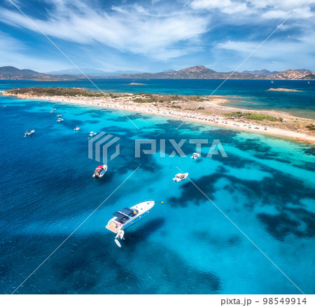 Aerial view of luxury yachts on blue sea and sandy beach 98549914