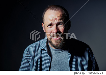 Portrait of mature man with confused expression Portrait of mature man with confused expression 98560771