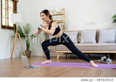 Fit asian woman training fitness exercise sport workout online class on laptop computer at home Fit asian woman training fitness exercise sport workout online class on laptop computer at home 98563918