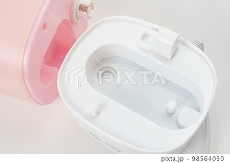 disassembled pink humidifier on a white background. device for home disassembled pink humidifier on a white background. device for home 98564030