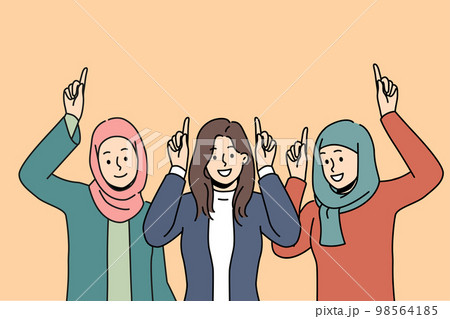 Smiling Arabic women point up at deal Smiling Arabic women point up at deal 98564185