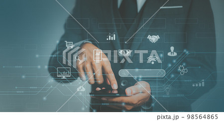 Businessman useing a smartphone connect to online data information. technology IoT, internet of things concept.. Businessman useing a smartphone connect to online data information. technology IoT, internet of things concept.. 98564865
