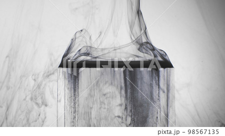 Steam floating. Ice cube. Ink water. Blur black smog vapor flow on transparent glass geometric figure on white abstract background. 98567135