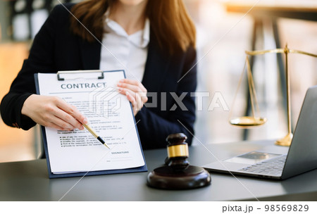justice and law concept.Male judge in a courtroom the gavel, working with smart phone and laptop and digital tablet computer on wood table in morning light justice and law concept.Male judge in a courtroom the gavel, working with smart phone and laptop and digital tablet computer on wood table in morning light 98569829