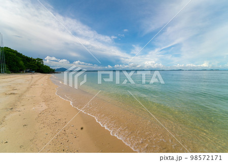 Sea beach wave splash on white sand beach against blue sky cloud Sea beach wave splash on white sand beach against blue sky cloud 98572171