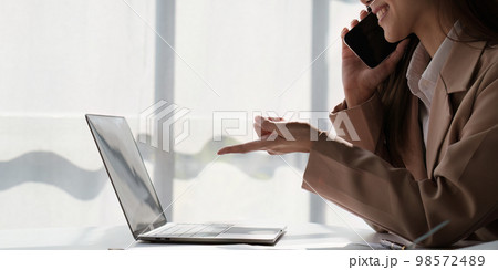 Asian Business woman working at home office and analyze financial report document. Accounting and Finance concept 98572489