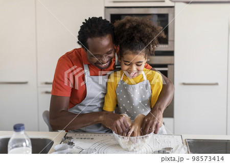 Family Leisure. Black Father And Daughter Kneading Dough While Baking At Home Family Leisure. Black Father And Daughter Kneading Dough While Baking At Home 98573414