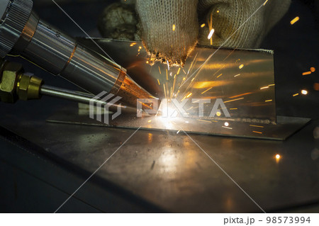 Close up scene the welding process with the sparking light. 98573994