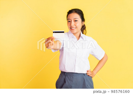 Smiling high school girl holding blank card on isolated background 98576160