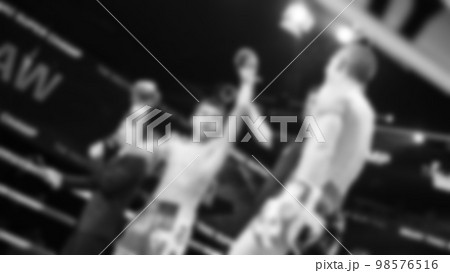 Blurred images black and white photo style of Thai boxing or Muay Thai or Kickboxing which local and foriegn boxer are fighting on the ring at indoor stage as martial art sport. Muay Thai Kick boxing Blurred images black and white photo style of Thai boxing or Muay Thai or Kickboxing which local and foriegn boxer are fighting on the ring at indoor stage as martial art sport. Muay Thai Kick boxing 98576516