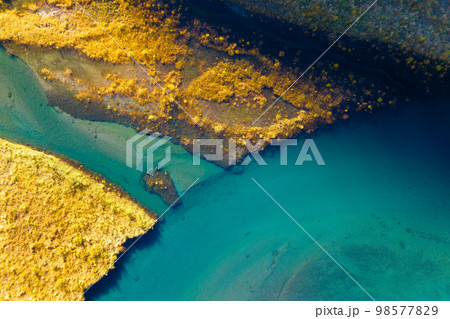 A drone view of the river . An aerial view of an autumn field. Pond among the meadows. 98577829