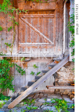 An antique entrance to the house. Stairs at the front door to the living quarters. 98577835