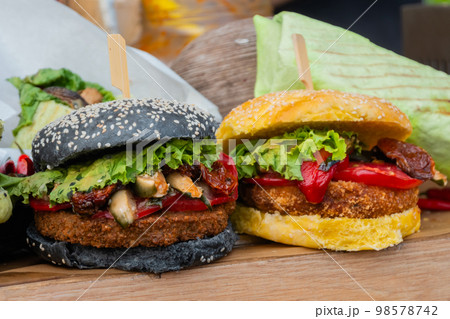 Fresh colorful vegan burgers with vegetables on counter at summer local food 98578742