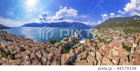 italian lakes scenery - beautiful Lago di Garda. Aerial panorama of Malcesine castle ,village and beach. 98579198