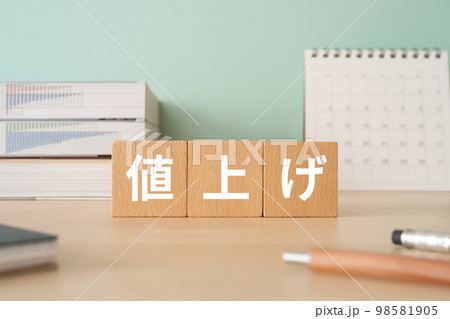 値上げと書かれたブロックが置かれたデスク 98581905