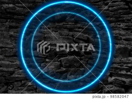 Blue glowing neon circles on black grunge stone wall 98582047