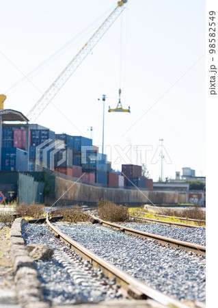 Railways near the warehouse with a bunch of containers in the open air 98582549