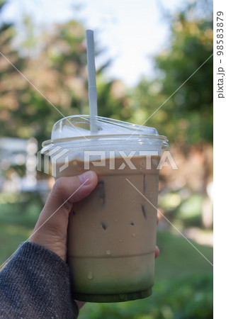 Woman hold her iced coffee 98583879