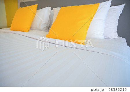 yellow pillow on white bed, interior design 98586216