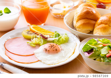 朝食、朝、食事、家、住居、食卓、パン、野菜、サラダ、卵、目玉焼き、スクランブルエッグ、ケチャップ、ウ 98587169