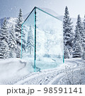 glass cube in the winter forest. 98591141