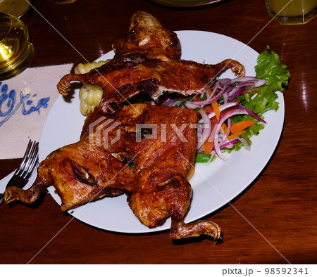 Close-up view to grilled cuy aka Guinea pig, Traditional peruvian dish, Arequipa, Peru 98592341