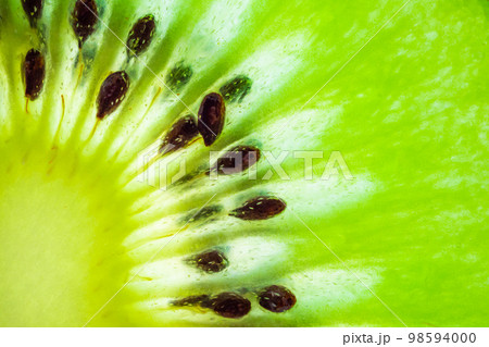 Fresh kiwi fruit slices closeup macro texture background Fresh kiwi fruit slices closeup macro texture background 98594000