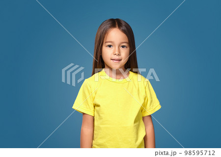 Little girl is smiling in yellow t-shirt 98595712