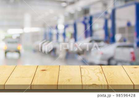 Empty wood table top with car service centre auto repair workshop blurred background Empty wood table top with car service centre auto repair workshop blurred background 98596428