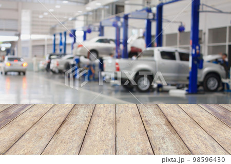 Wood table top with blur garage background Wood table top with blur garage background 98596430