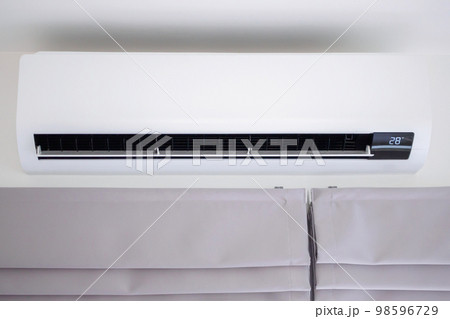 Air conditioner on white wall room interior background Air conditioner on white wall room interior background 98596729