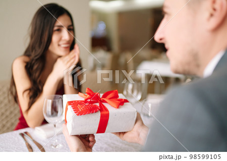 Valentine's Day concept. Happy couple in love. Couple celebrating Valentine's Day in restaurant. Valentine's Day concept. Happy couple in love. Couple celebrating Valentine's Day in restaurant. 98599105