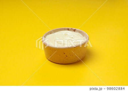 Concept of egg sauce, mayonnaise on yellow background Concept of egg sauce, mayonnaise on yellow background 98602884