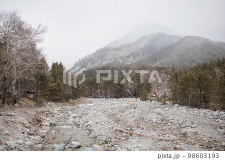 A village in thick fog in the mountains 98603193