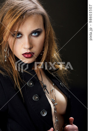 Beautiful stylish woman with curly hair in a jacket and perfect bra 98603507