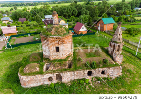 General aerial view of the overgrown ruins of an ancient red brick Orthodox church in the village General aerial view of the overgrown ruins of an ancient red brick Orthodox church in the village 98604279