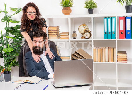 Ambitious girl embrace manager working in office, flirting Ambitious girl embrace manager working in office, flirting 98604408