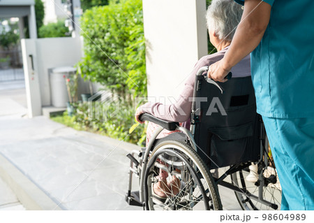 Caregiver help and care Asian senior or elderly old lady woman patient sitting in wheelchair on ramp at nursing hospital, healthy strong medical concept Caregiver help and care Asian senior or elderly old lady woman patient sitting in wheelchair on ramp at nursing hospital, healthy strong medical concept 98604989