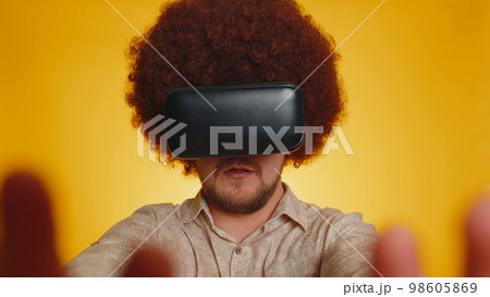 Man using virtual reality headset helmet app to play simulation innovation 3D game in VR goggles 98605869