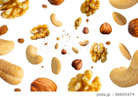 Collection of tasty crispy Hazelnut, Wallnut, Pecan nut, almond and sultana raisins falling isolated on white background. Concept organic diet mix. Selective focus 98605874