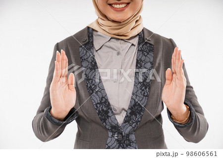 a woman with hijab opened her hands with the empty space between 98606561