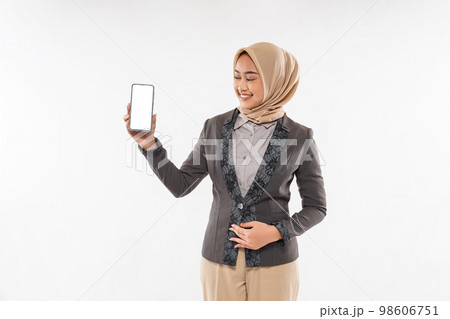 a woman with hijab standing and showing the phone at her hand 98606751