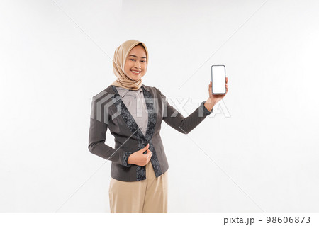 a beautiful woman with hijab showing the phone and smiling a beautiful woman with hijab showing the phone and smiling 98606873