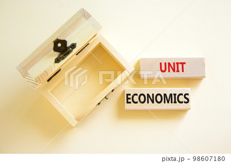 Unit economics symbol. Concept words Unit economics on wooden blocks. Beautiful white table white background. Wooden empthy chest. Business and unit economics concept. Copy space. Unit economics symbol. Concept words Unit economics on wooden blocks. Beautiful white table white background. Wooden empthy chest. Business and unit economics concept. Copy space. 98607180
