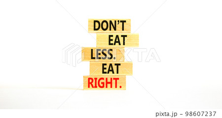 Eat less or right symbol. Concept words Do not eat less, eat right on wooden blocks. Beautiful white table white background. Healthy lifestyle and eat less or right concept. Copy space. Eat less or right symbol. Concept words Do not eat less, eat right on wooden blocks. Beautiful white table white background. Healthy lifestyle and eat less or right concept. Copy space. 98607237